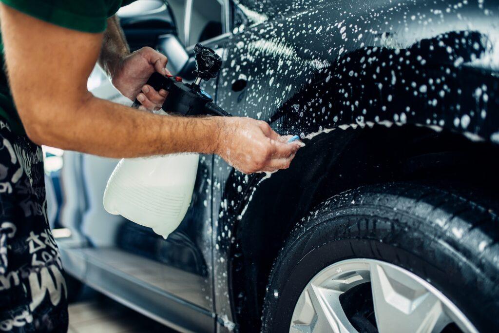 worker disperses soapy water in exterior detailing process at loves auto detail in kapolei hawaii