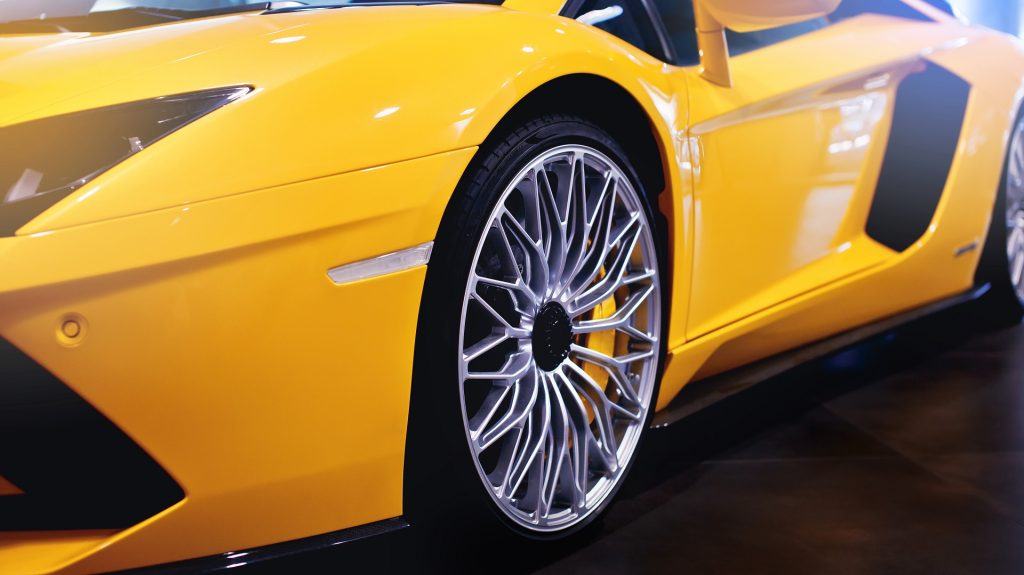 a brand new yellow sport car with luxury stylish wheels look shining after paint correction service at loves auto details in kapolei hawaii